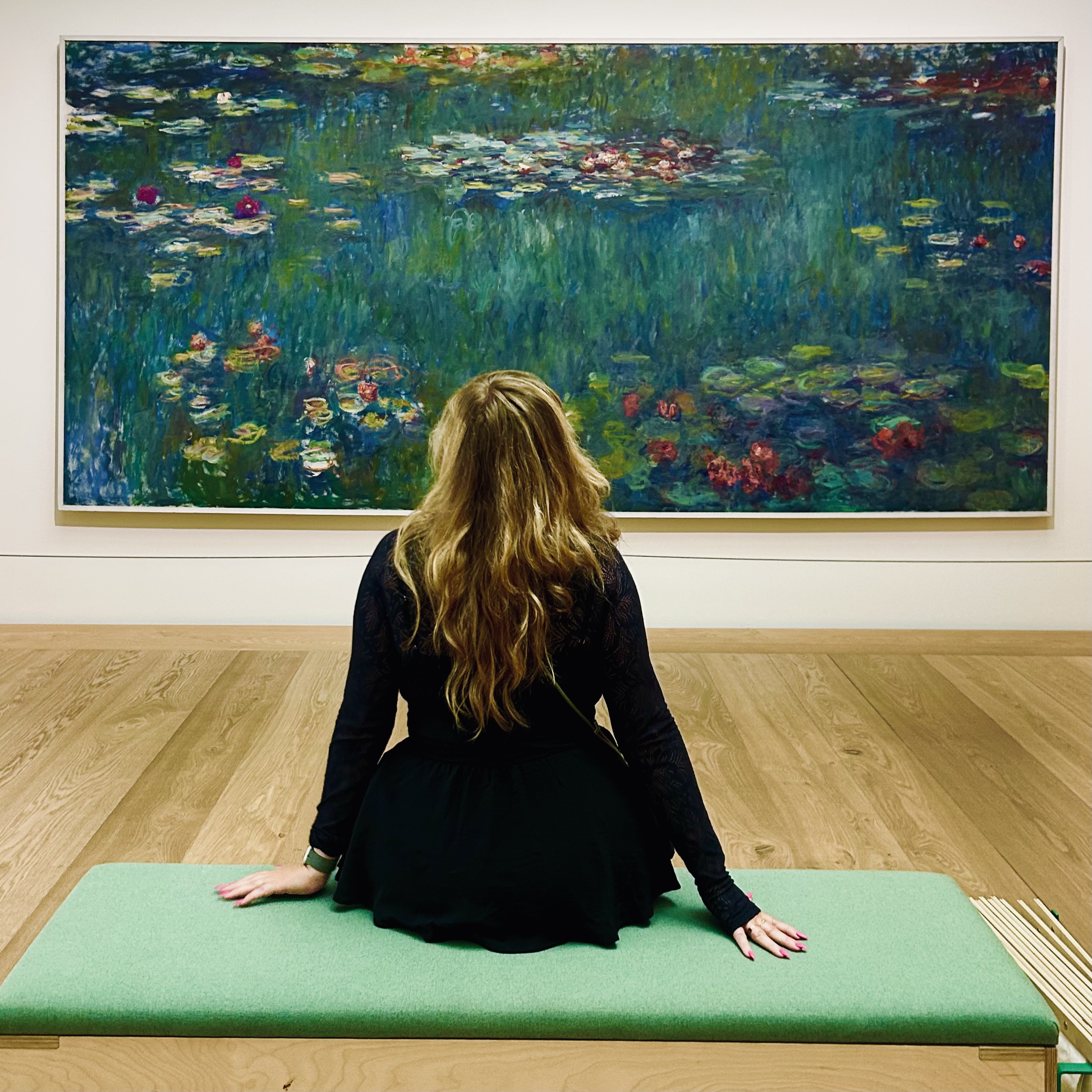 Person viewing a large painting in an art gallery